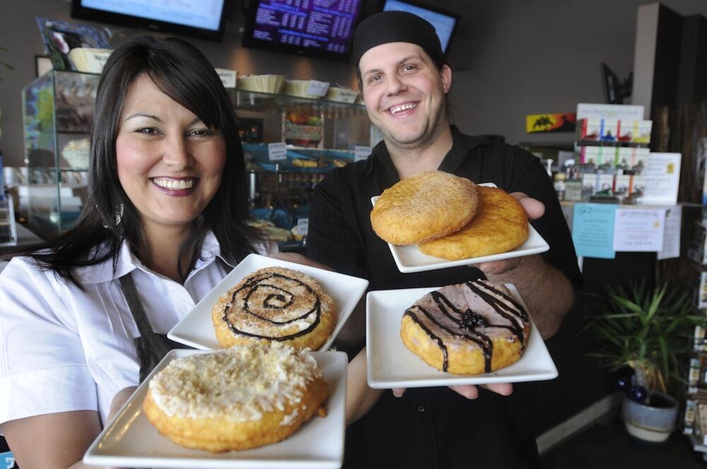 Kekuli Cafe owners Sharon Bond and Darren Hogg holding a variety of plated bannock treats.